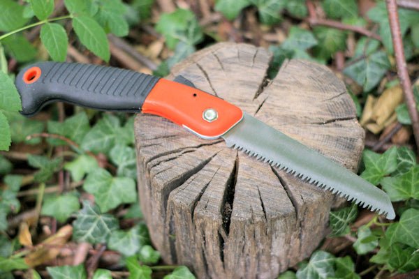 Small folding Orange saw to meet the demands of gardening, camping, hiking, and survival prepping. Folding Saw Hugginsattic    [Huggins attic]