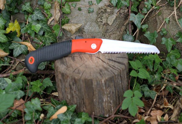 Small folding Orange saw to meet the demands of gardening, camping, hiking, and survival prepping. Folding Saw Hugginsattic    [Huggins attic]