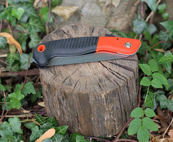 Small folding Orange saw to meet the demands of gardening, camping, hiking, and survival prepping. Folding Saw Hugginsattic    [Huggins attic]